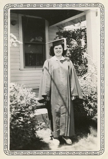 photograph of Dorothy Lorraine Fiegenbaum in her graduation robe in front of the house