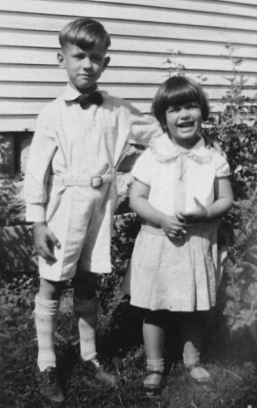 photographic portrait of J. W. with his arm around the shoulders of his sister, Dorothy L. Fiegenbaum, who is laughing