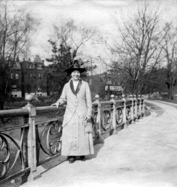 photo of Selma Anna Gerber standing on a bridge in a city park